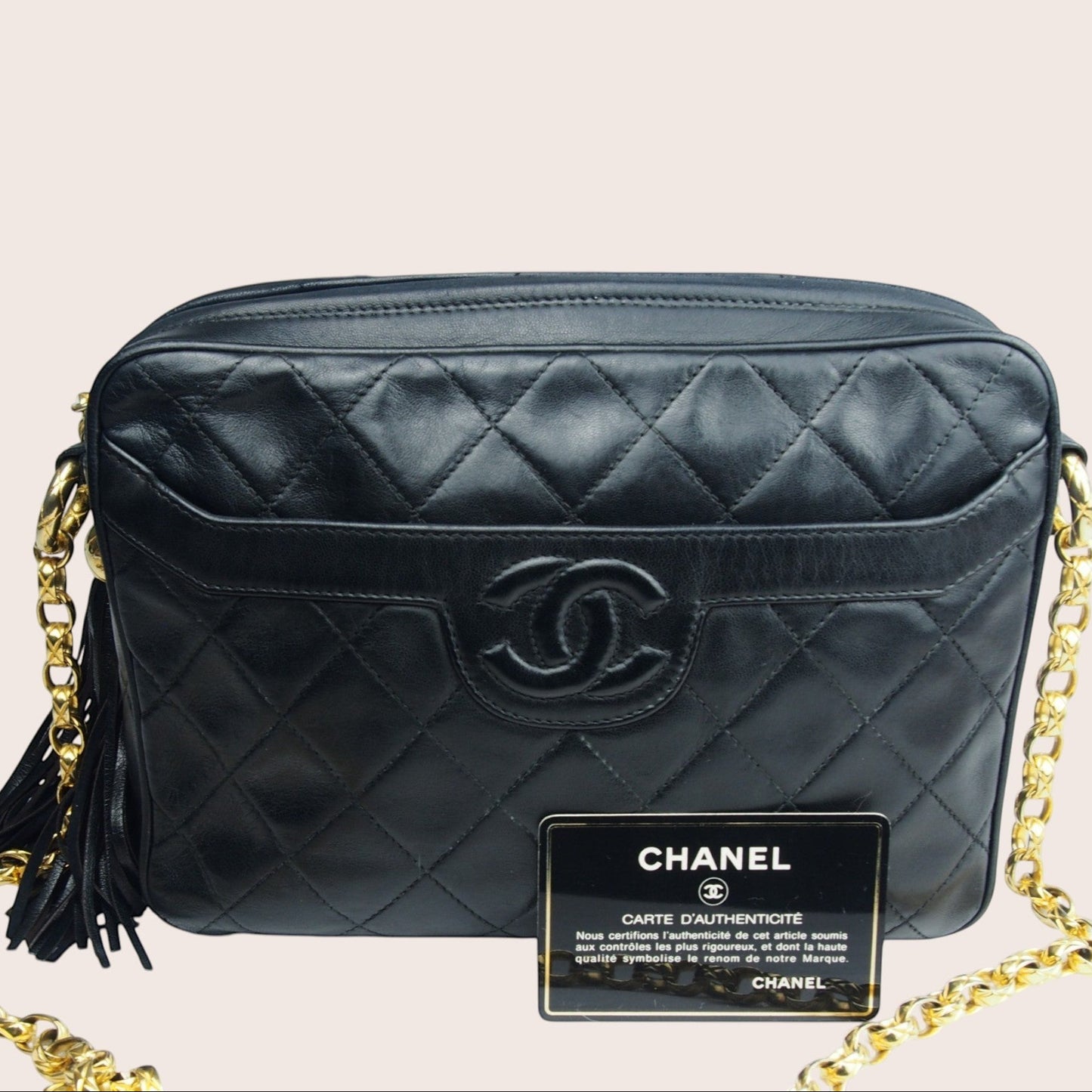 Nandalee black quilted lambskin Chanel Single Flap vintage camera bag with gold chain and tassel.
