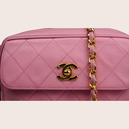 Nandalee pink quilted lambskin Chanel camera bag with gold hardware and chain strap.