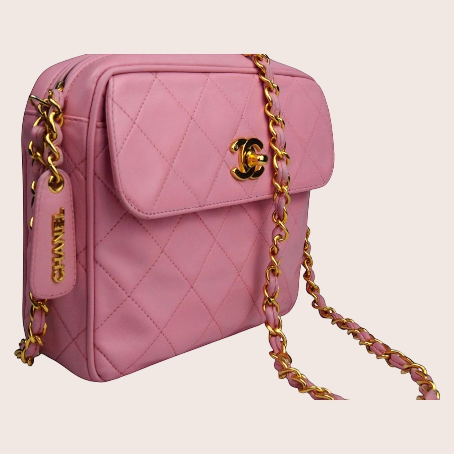 Nandalee pink quilted lambskin Chanel camera bag with gold hardware and tassel detail.