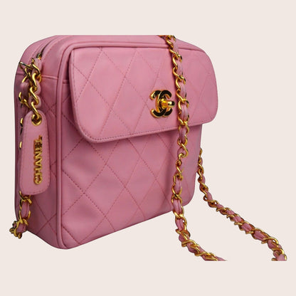 Nandalee pink quilted lambskin Chanel camera bag with gold hardware and tassel detail.