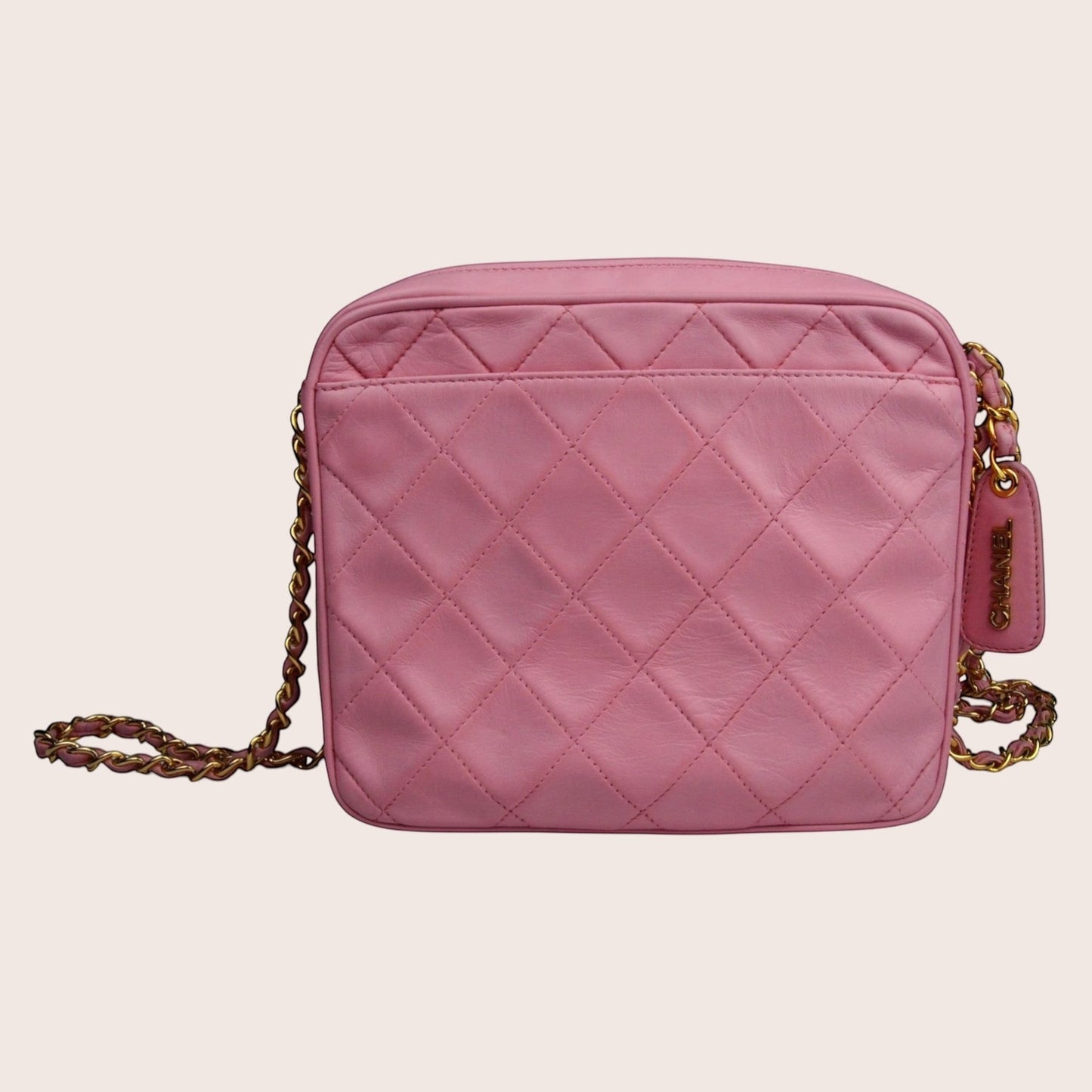Nandalee pink quilted leather Chanel camera bag with gold chain strap and tassel detail.