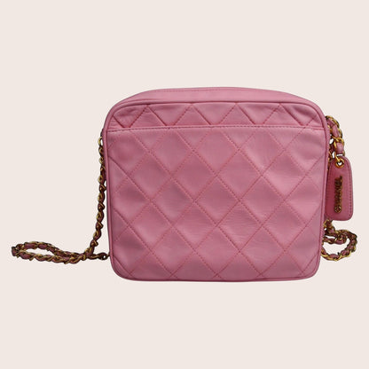 Nandalee pink quilted leather Chanel camera bag with gold chain strap and tassel detail.