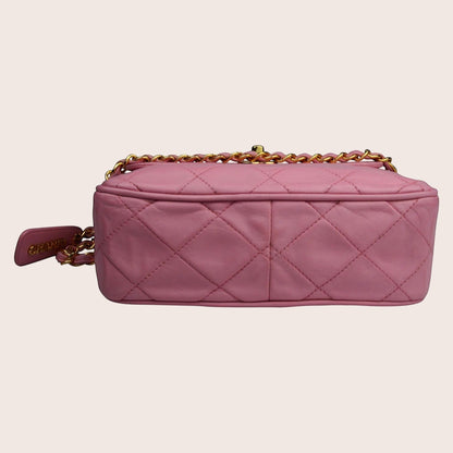 Nandalee pink quilted leather Chanel camera bag with gold chain and tassel detail.