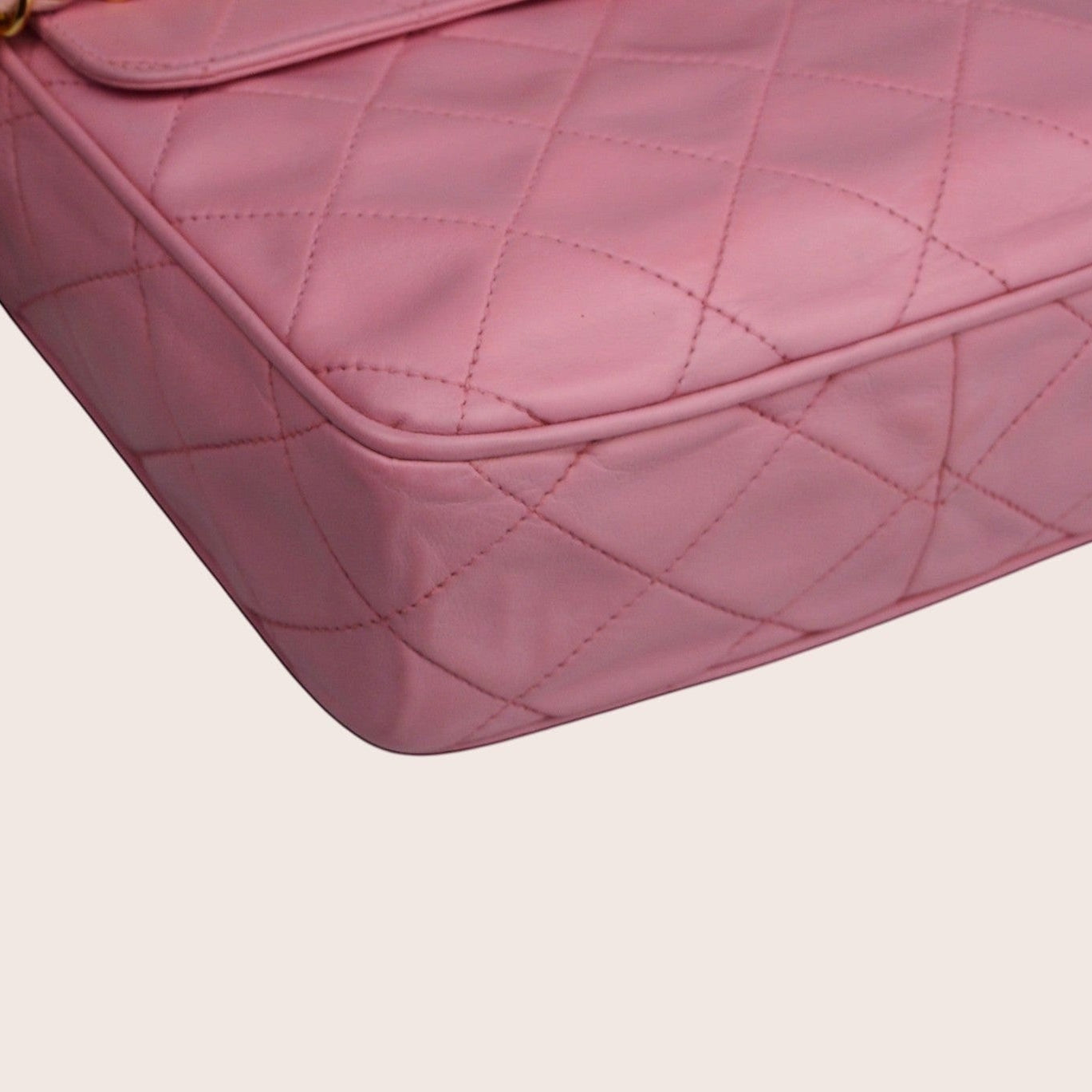 Nandalee pink quilted lambskin leather Chanel camera bag with gold chain strap and tassel detail.