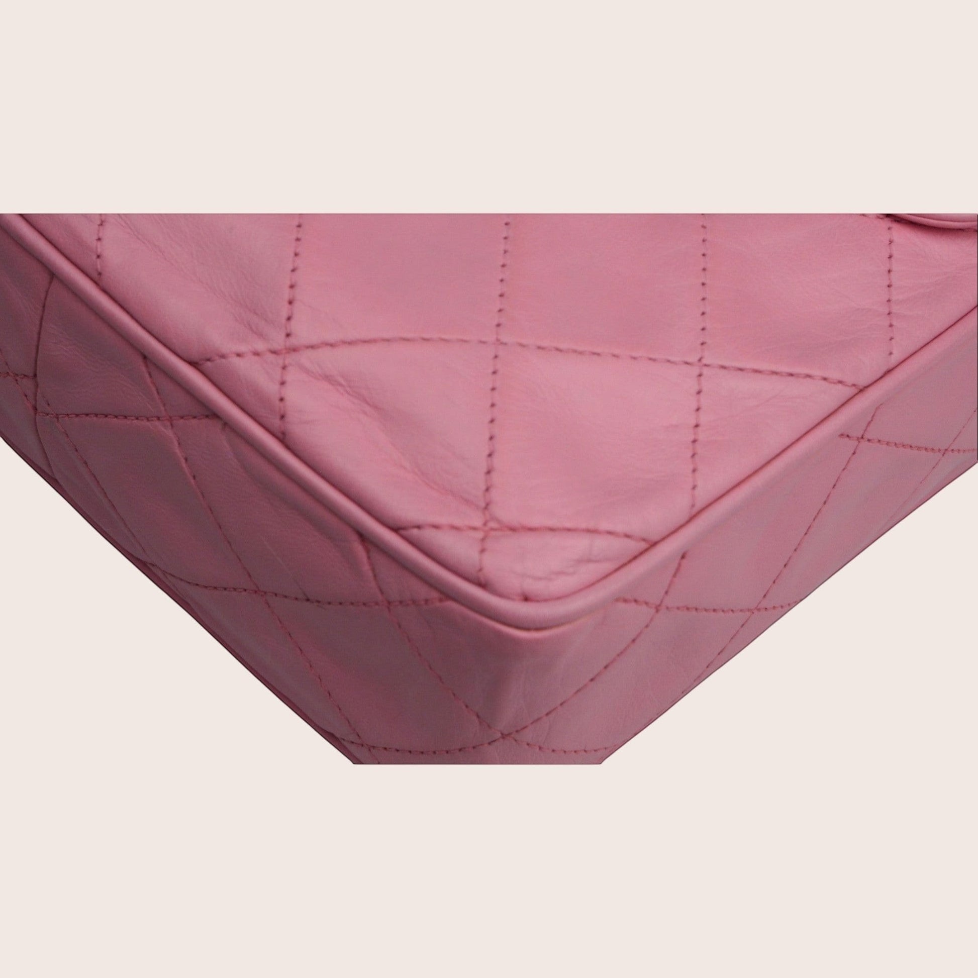 Nandalee pink quilted leather Chanel camera bag with gold hardware and tassel detail.