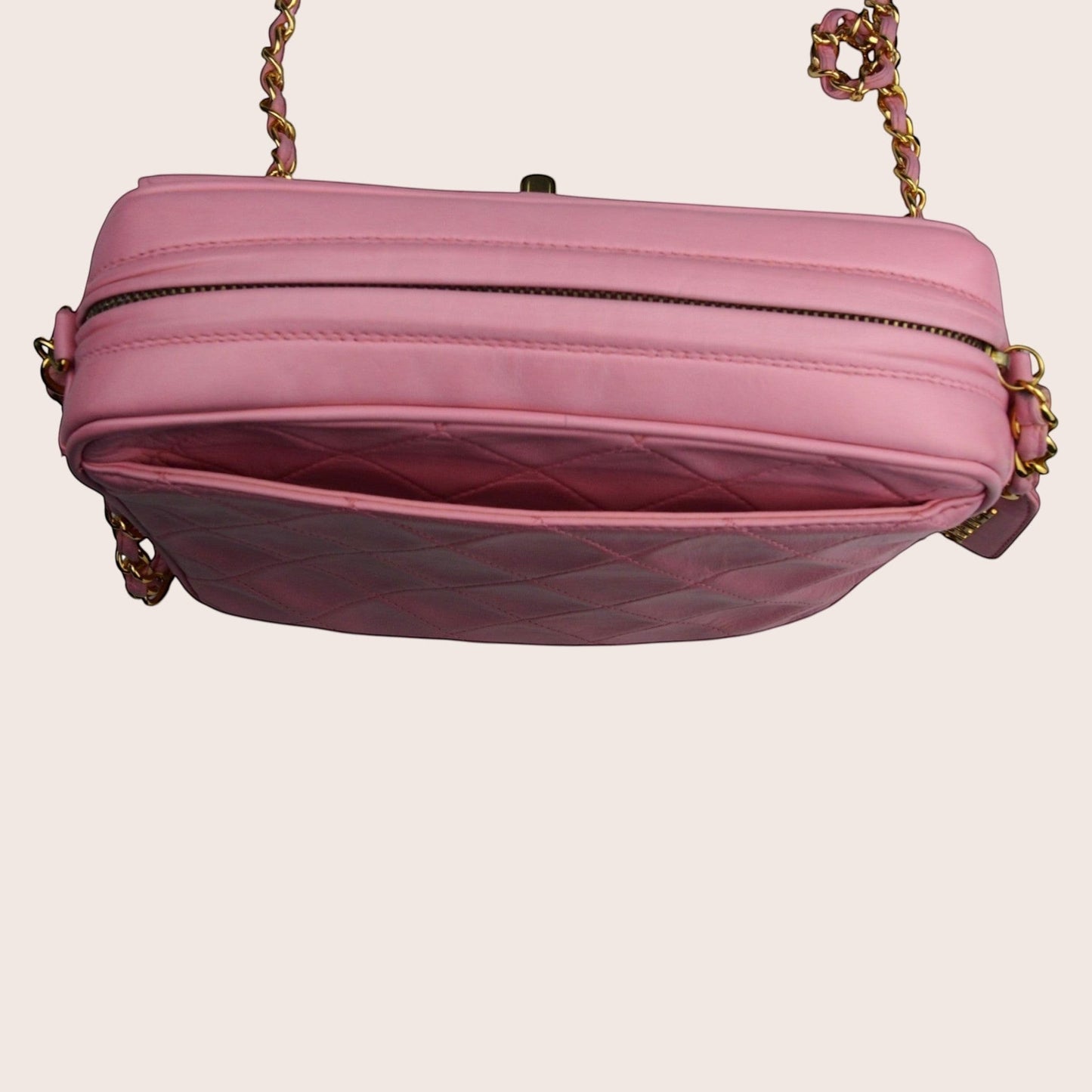 Nandalee pink quilted leather Chanel camera bag with gold chain strap and tassel detail.