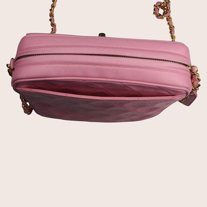 Nandalee pink quilted leather Chanel camera bag with gold chain strap and tassel detail.