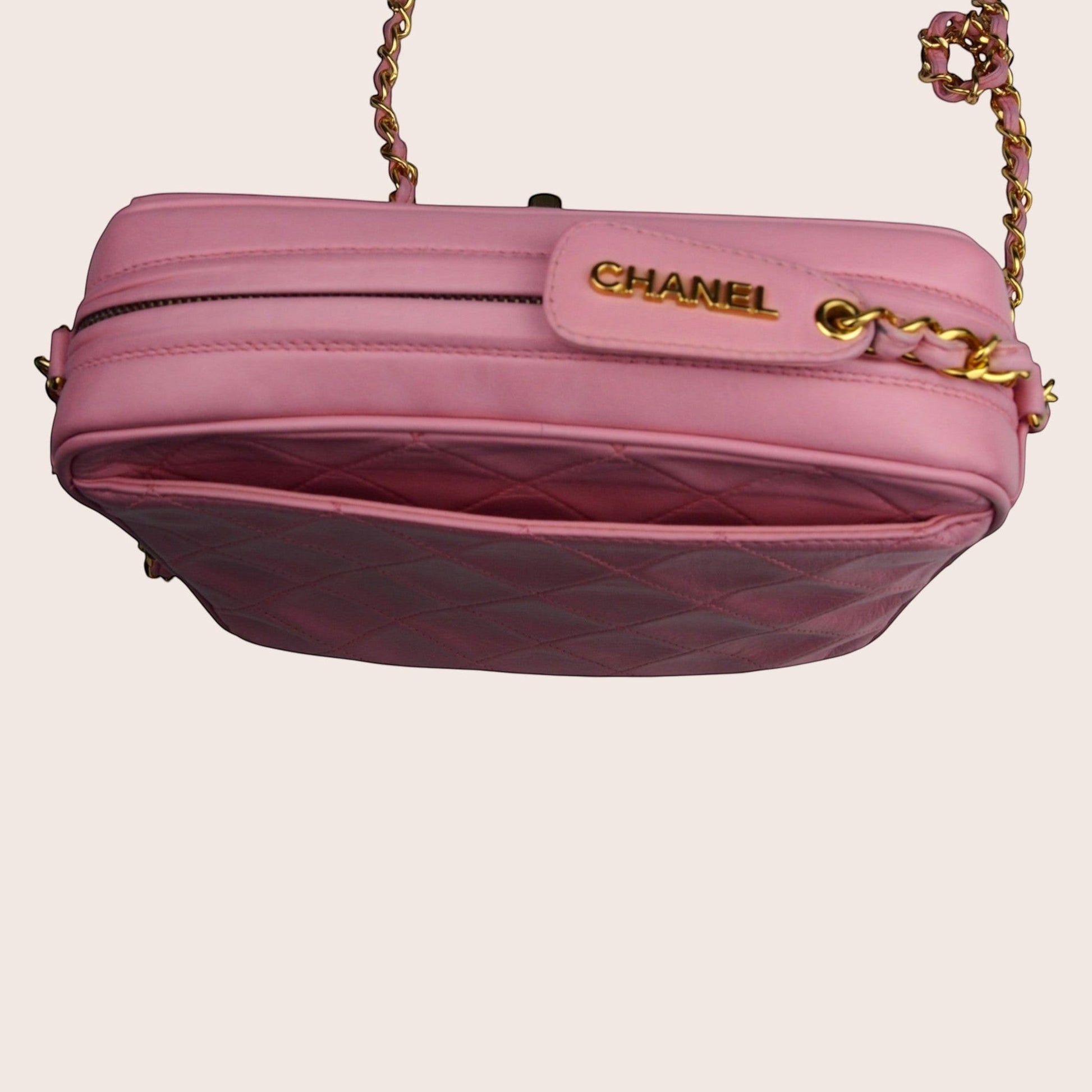 Nandalee pink quilted lambskin Chanel camera bag with gold chain and tassel detail.