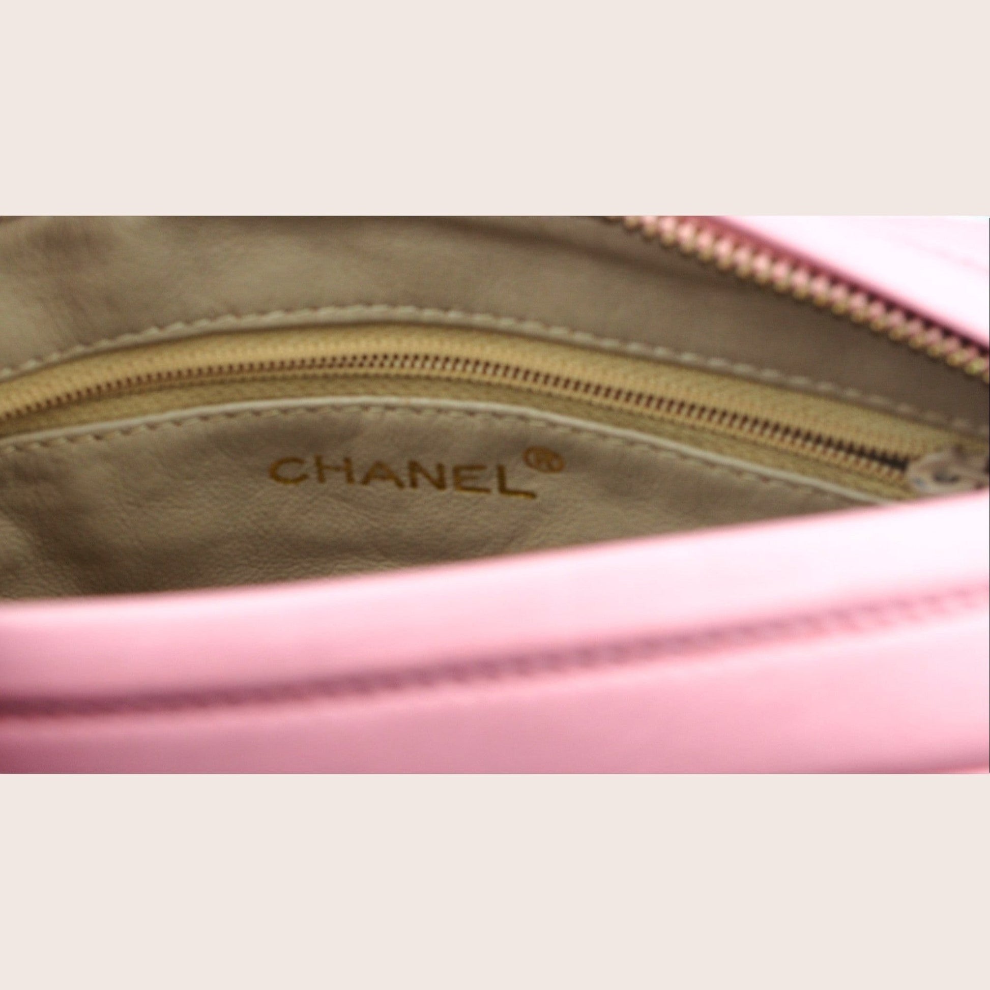 Nandalee pink Chanel camera bag in lambskin leather with gold hardware and tassel detail.