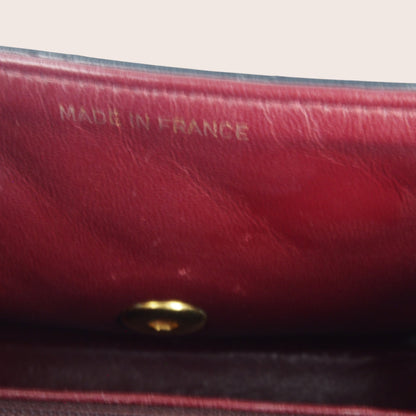 Innenansicht der Chanel Mini Bijoux Tasche mit geprägtem Chanel-Logo im bordeauxfarbenen Lederfutter.