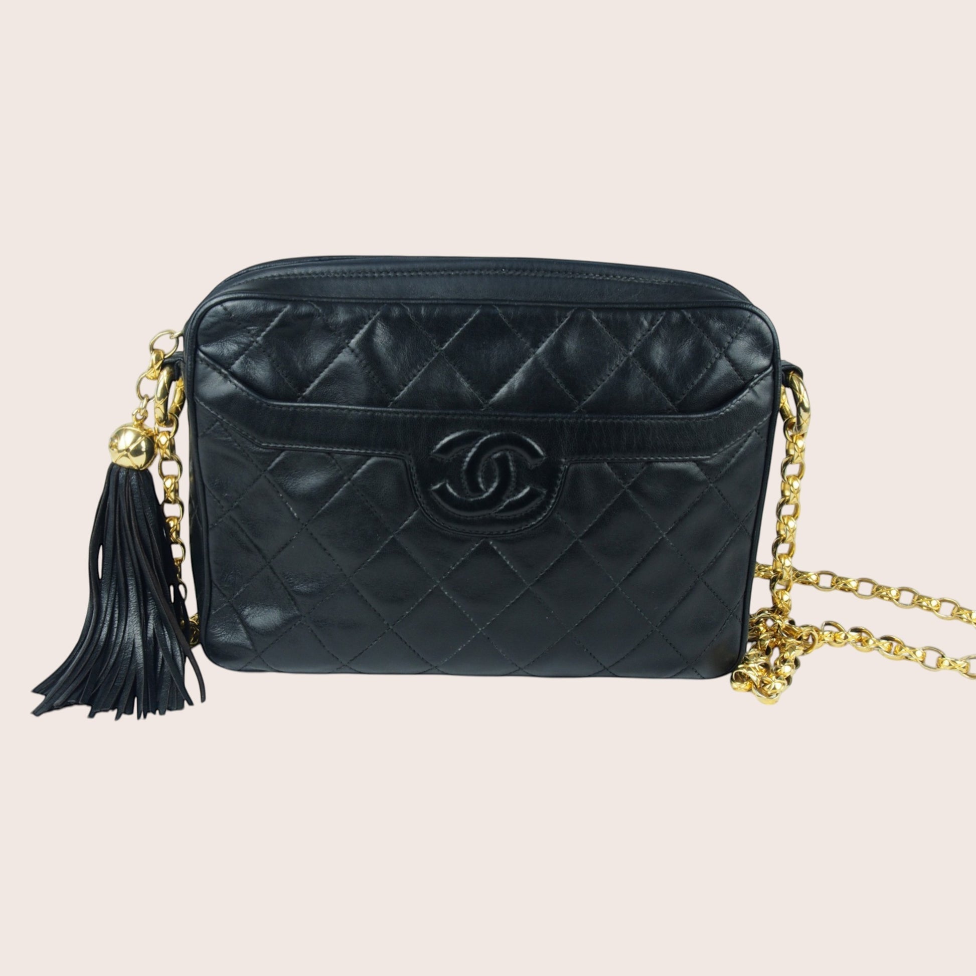 Nandalee black quilted lambskin Chanel Single Flap vintage camera bag with gold chain and tassel.