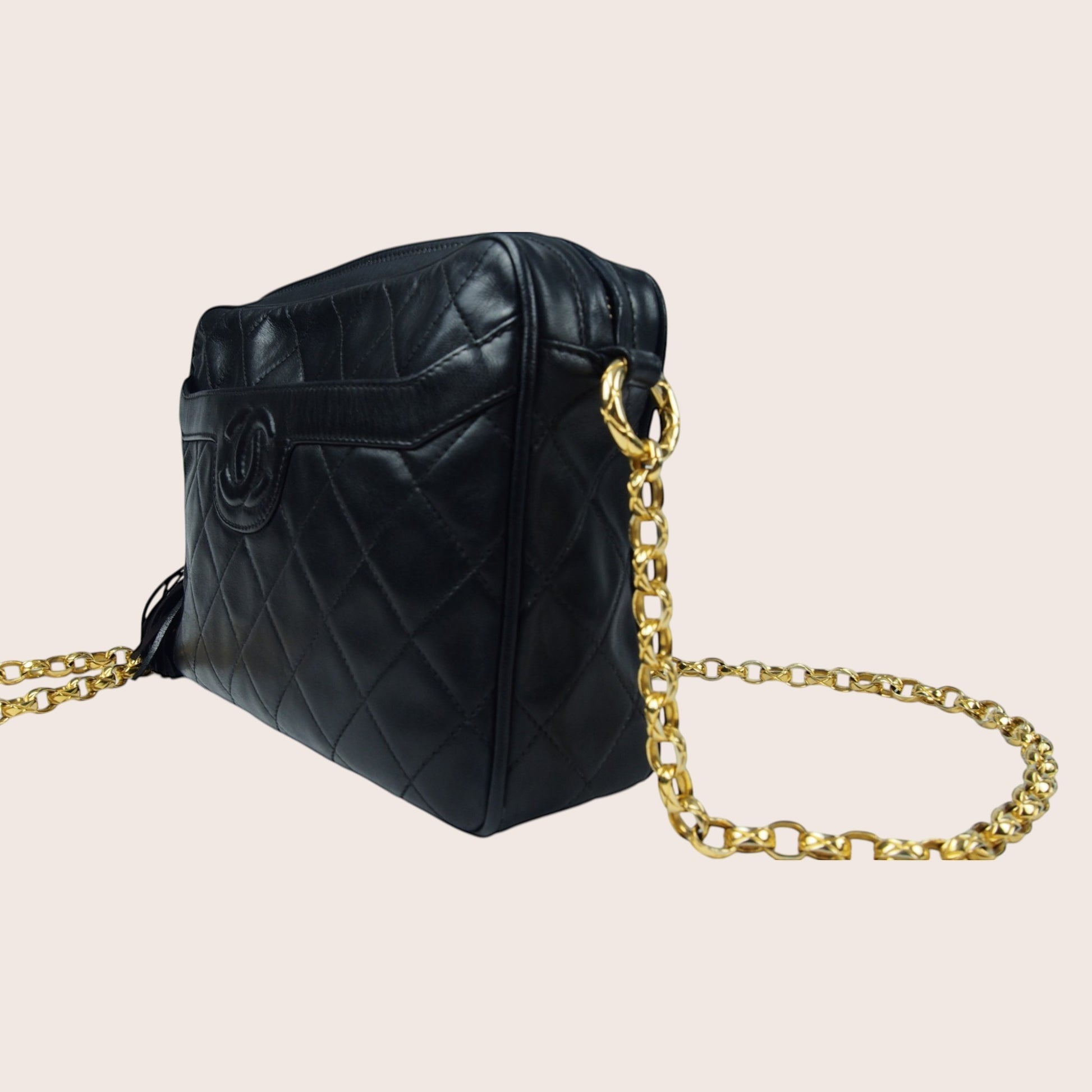 Nandalee black quilted lambskin Chanel Single Flap vintage camera bag with gold chain strap.