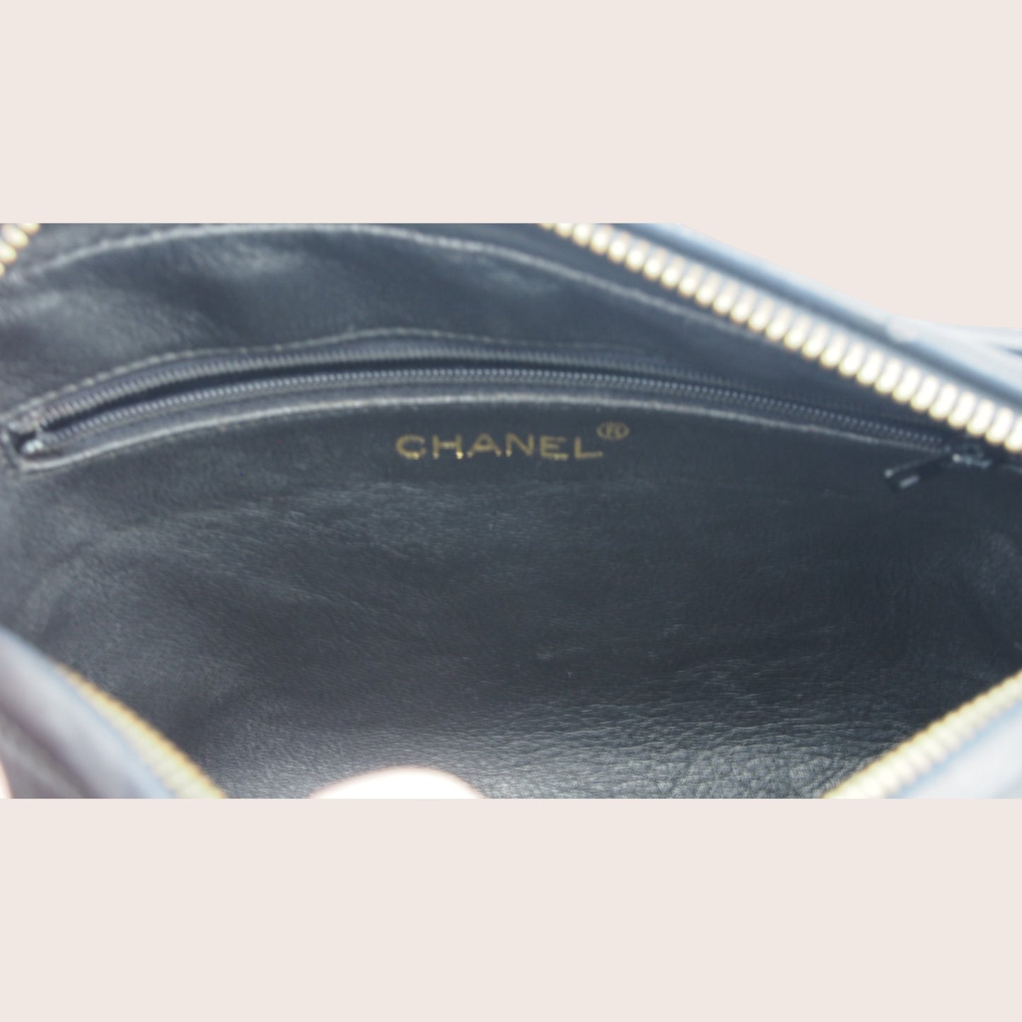 Nandalee black lambskin Chanel Single Flap vintage camera bag with gold hardware and embossed logo.