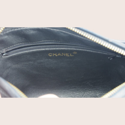 Nandalee black lambskin Chanel Single Flap vintage camera bag with gold hardware and embossed logo.