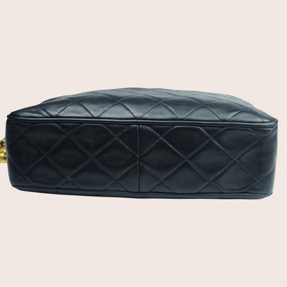 Nandalee black lambskin Chanel Single Flap vintage camera bag with gold chain strap and diamond quilting.