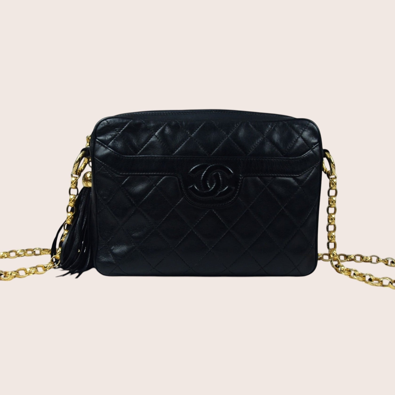 Nandalee black lambskin leather Chanel camera bag with gold chain strap and tassel detail. Vintage single flap design.