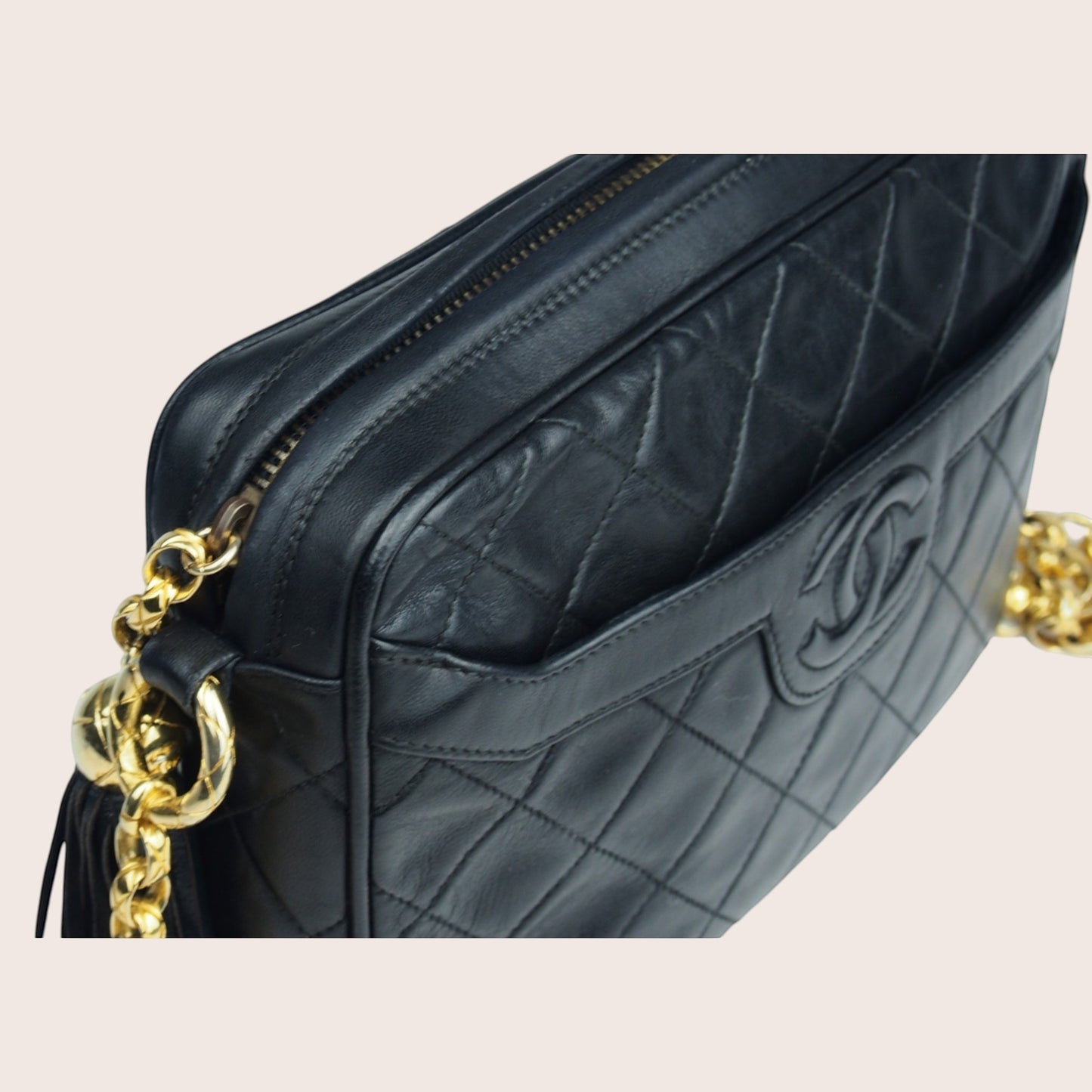 Nandalee black lambskin Chanel Single Flap vintage camera bag with gold chain and tassel.