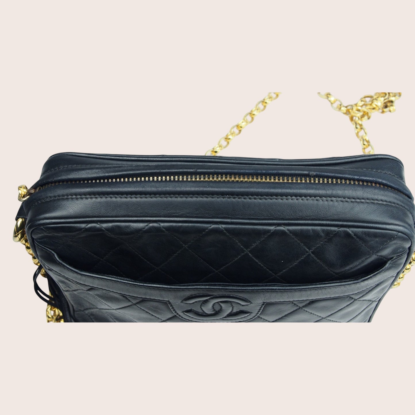 Nandalee black lambskin Chanel Single Flap vintage camera bag with gold chain strap and quilted diamond pattern.
